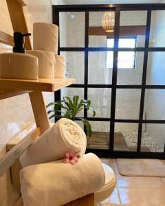 a pile of towels sitting on a toilet in a room at Casa Mayo B&B in Oaxaca City