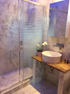 a bathroom with a sink and a shower at Vergos Hotel in Vourvourou