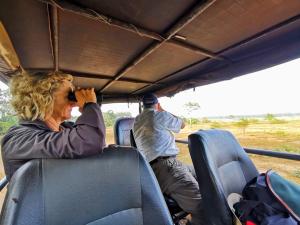 a man and a woman sitting in the back of a bus at Big Game Yala - by Eco Team in Yala