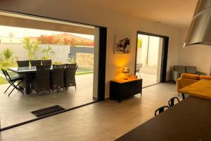 a living room with a table and chairs and a dining room at VILLA Paolo in Saint-Christol-lès-Alès