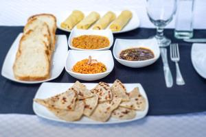 a table with plates of food and bread on it at Big Game Yala - by Eco Team in Yala +88 photos
