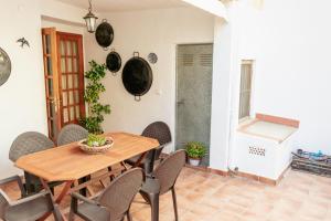 a dining room with a wooden table and chairs at Casa rural- Casa Liberta in Canet lo Roig