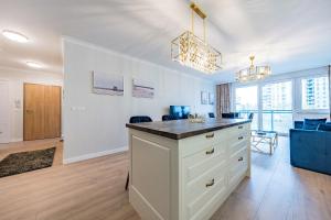 a kitchen with a large island in a room at Nowa Letnica Apartament in Gdańsk