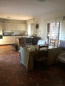 a kitchen with a table and some chairs and a kitchen withilitation at Villa Pilar in Aledo