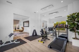 a room with a gym with exercise equipment in it at Alfred Villa in Los Angeles