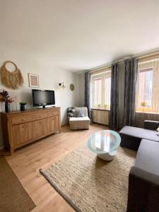 a living room with a couch and a coffee table at Apartament Starogdański 4 in Gdańsk