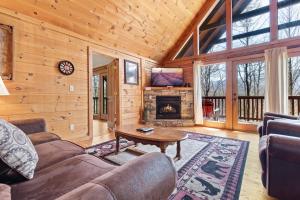 a living room with a couch and a fireplace at Above the Clouds, 4 Bedrooms, Pool Access, Private, Gaming, Sleeps 16 in Gatlinburg