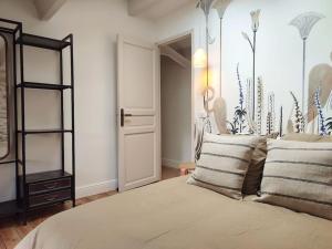 a bedroom with a bed with pillows on it at Uzès médiévale l'écrin d'Amalia in Uzès