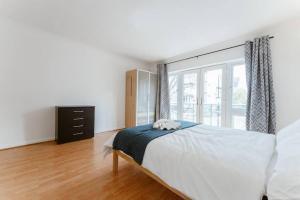 a bedroom with a bed and a large window at Up to 4 people, Room In a Share house next to London Bridge in London