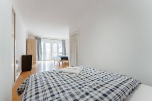 a white bedroom with a black and white bed at Up to 4 people, Room In a Share house next to London Bridge in London