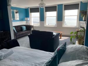 a living room with a bed and a couch at Paragon Home in Ramsgate