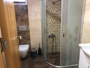 a bathroom with a shower with a toilet and a sink at Seyran Seaside Apartments - 2-dublex in Trabzon