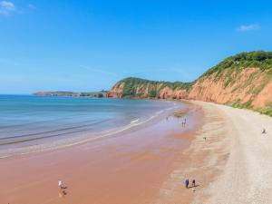 a group of people walking on the beach at Cornerside in Sidmouth