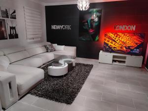 a living room with a white couch and a tv at villa bonita in Corralejo