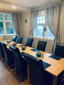 a conference room with a wooden table and chairs at Navaar House Hotel in Penicuik