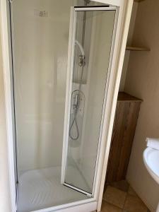 a shower with a glass door in a bathroom at Setons Getaway in Port Seton