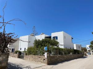 a row of white buildings on a street at Villa Gelly's Studios in Aliki