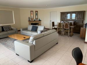a living room with a couch and a table at Ocean Vista Beach Stay in Rockingham