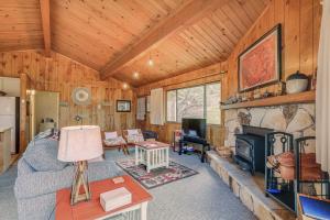 a living room with a couch and a fireplace at Serene Groveland Cabin Rental Near Yosemite! in Groveland