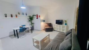 a living room with a couch and a table at Apartamentos azayara in Frontera