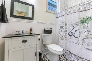 a bathroom with a toilet and a shower curtain at La Belle Luxe 3qnbed, walk to street car! in New Orleans +12 photos
