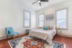 a bedroom with a bed and a blue chair at La Belle Luxe 3qnbed, walk to street car! in New Orleans