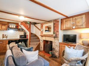 a living room with a couch and a fireplace at Delft Cottage in Robin Hood's Bay