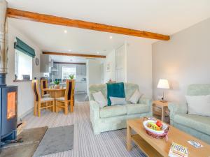 a living room with two chairs and a table at The Cottage Middle West Water in Axminster