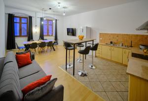a living room and kitchen with a couch and a table at Urania Apartamenty in Kowary