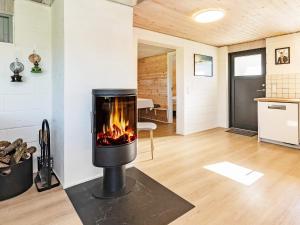 a fireplace in the living room of a house at 6 person holiday home in Vesløs-By Traum in Øsløs