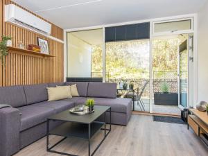 a living room with a couch and a table at 2 person holiday home in Ringkøbing in Ringkøbing