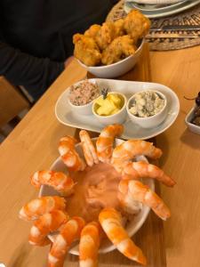 a table topped with plates of shrimp and dips at Quintinha da Oliveira in Marco de Canavezes