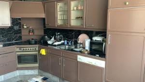 a kitchen with brown cabinets and a sink and a refrigerator at Wow in Rotterdam
