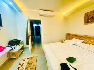 a bedroom with a large white bed in a room at Scandic Rezort in Hurghada +19 photos