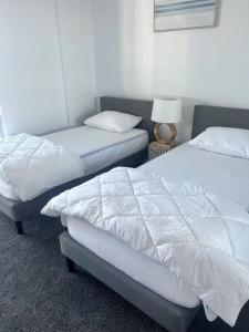 A bed or beds in a room at Pavillions - Hosted by Burleigh Letting