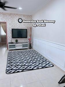 Una televisión o centro de entretenimiento en Homestay Anak Mommy