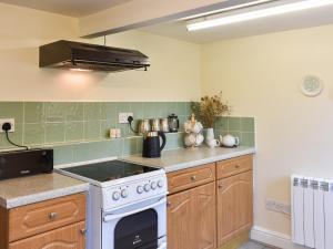 a kitchen with a white stove top oven at Sandwath in Temple Sowerby