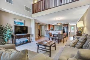 a living room with a couch and a table at Palm Villas 2 Bed/2 Bath Loft #F22 in Waikoloa