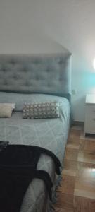 um quarto com uma cama com uma cabeceira azul em Apart hotel protomy em Villa Luzuriaga