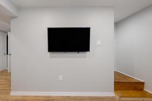 a flat screen tv on a white wall at Peace by Province Lake in Wakefield