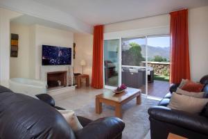 a living room with a couch and a fireplace at Mediterranean Townhouse CalaGolf in Mijas