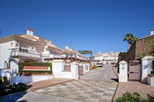 a row of white houses on a street at Mediterranean Townhouse CalaGolf in Mijas