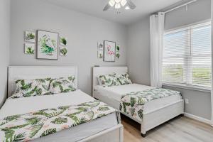 a bedroom with two beds and a window at Dawn Patrol in City-by-the Sea +23 photos