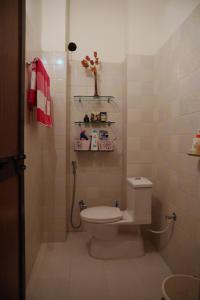 a small bathroom with a toilet and a sink at Tattva Luxurious Apartment in Varanasi