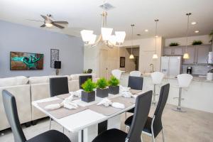 comedor y sala de estar con mesa blanca y sillas en Four Bedroom Close to Disney 5149A, en Kissimmee