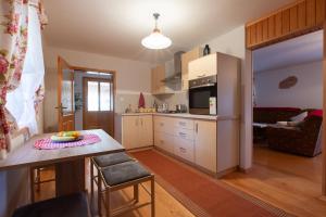 a kitchen with a table and a counter top at Holiday house with a parking space Jasenak, Karlovac - 20579 in Jasenak