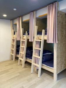 a group of bunk beds in a room at Cloud Sharing Hotel Hakata 1 in Fukuoka