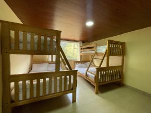 a room with two bunk beds and a window at Penthouse w/rooftop terrace - volcano view in Baños
