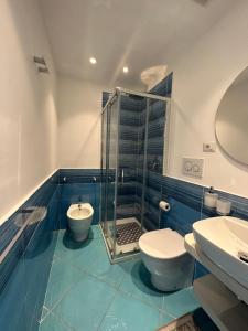 a bathroom with a shower and a toilet and a sink at De Riso Apartments Luxury Amalfi Coast in Minori +30 photos