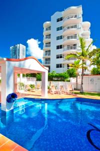 a swimming pool in front of a building at The Ritz Resort Heated Pool in Gold Coast